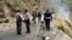 FILE - Security personnel inspect the site of a suicide attack in the Shangla district of Pakistan's Khyber Pakhtunkhwa province on March 26, 2024. Five Chinese nationals working on a construction site were killed along with their driver by a suicide bomber.
