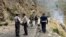 Security personnel inspect the site of a suicide attack in the Shangla district of Pakistan's Khyber Pakhtunkhwa province on March 26, 2024. Five Chinese nationals working on a construction site were killed along with their driver by a suicide bomber.