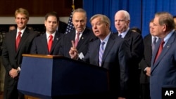 FILE - Sen. Lindsey Graham, center, speaks of immigration reform legislation outlined by the Senate's "Gang of Eight" that would create a path for unauthorized immigrants to apply for U.S. citizenship, April 18, 2013, in Washington.