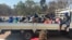 Arrested Zimbabwe election monitors, crammed into an open truck, arrive at Harare Magistrates Court, Aug. 25, 2023. (Columbus Mavhunga/VOA)