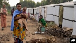 FILE - A woman and child among those displaced by fighting are pictured at a refugee camp on the outskirts of Goma, Democratic Republic of the Congo, July 11, 2024.