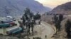 FILE - Trucks loaded with goods are seen parked at border crossing point Torkham in Afghanistan's eastern Nangarhar province, on the country's border with Pakistan, Feb. 21, 2023.