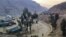 FILE - Trucks loaded with goods are seen parked at border crossing point Torkham in Afghanistan's eastern Nangarhar province, on the country's border with Pakistan, Feb. 21, 2023.