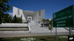 FILE - Lawyers gather outside Pakistan's Supreme Court in Islamabad, April 4, 2023. The court issued notices June 5, 2024, to 34 news channels, demanding explanations for airing two press conferences critical of the judiciary. 