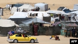 Displaced Palestinians transport their belonging atop a car as they flee to a safer area in Rafah in the southern Gaza Strip on May 9, 2024. (Photo by AFP)