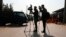 FILE - Afghan journalists film in Kabul, Afghanistan, Feb. 9, 2021. A Taliban-controlled state broadcaster muted microphones and refused to show images of a female journalist asking a question at a news conference in Kabul on Aug. 27, 2024.