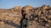 An Afghan girl cries in front of her house that was destroyed by the earthquake in Zindajan district in the Herat province of western Afghanistan, Oct. 11, 2023. 