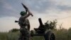 FILE - A Ukrainian serviceman fires a 122mm mortar towards Russian positions at the front line, near Bakhmut, Donetsk region, Ukraine, July 2, 2023. 