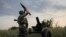 FILE - A Ukrainian serviceman fires a 122mm mortar towards Russian positions at the front line, near Bakhmut, Donetsk region, Ukraine, July 2, 2023. 