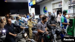 People wait for their turn to get fuel at a petrol station, after petrol dealers across the country announced they are going on strike against taxes imposed by the government, in Karachi, Pakistan, July 4, 2024.