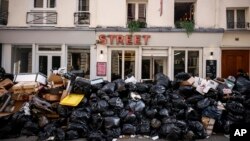Uncollected garbage is piled up on a street in Paris, March 15, 2023, during an ongoing strike by sanitation workers. (AP Photo/Thomas Padilla, File)