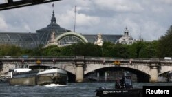 资料照片：在巴黎奥运会开幕前100天，一艘警察小艇在巴黎大皇宫附近的塞纳河上巡逻。(2024年4月17日)