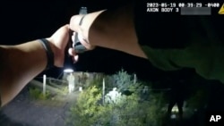 FILE - In this image taken from body camera video released June 22, 2023, by U.S. Customs and Border Protection, an agent points a gun at tribal member Raymond Mattia, May 19, in Tohono O'odham Nation, in southern Arizona.