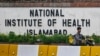 A delivery boy rides past the building of National Institute of Health (NIH), a Pakistani research institute mainly responsible for biomedical and health related research, in Islamabad, Aug. 16, 2024. 