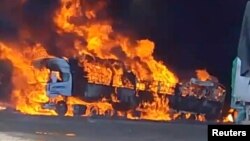 সোশ্যাল মিডিয়া ভিডিও থেকে প্রাপ্ত এই ছবিতে, মিয়ানমারের মিউজের কাছে মিয়ানমার-চীন সীমান্তের কাছে একটি ট্রাক পুড়ে ধোঁয়া উঠছে। ( ২৩ নভেম্বর, ২০২৩)