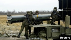 স্প্যানিশ সেনাবাহিনীর সদস্যরা লাটভিয়ার লিলভার্দে বিমান ঘাঁটিতে নাসামস বিমান প্রতিরক্ষা রকেট লঞ্চার ব্যবহার করছে। ২৯ শে মার্চ, ২০২৩। ফাইল ছবি। 