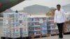 Indonesian President Joko Widodo walks by relief supplies during the inspection of aid for Palestinians in Gaza, before its departure at Halim Perdanakusuma air base in Jakarta, Indonesia, Nov. 4, 2023. 