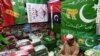 A shopkeeper arranges flags of political parties at his shop ahead of the upcoming general elections in Karachi, Pakistan, on Jan. 3, 2024. 