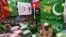 A shopkeeper arranges flags of political parties at his shop ahead of the upcoming general elections in Karachi, Pakistan, on Jan. 3, 2024. 
