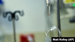 Saline fluid runs through a tube demonstrating how ketamine would be administered to a patient at the Duke Speciality Infusion Center on Friday, Oct. 27, 2023, in Durham, N.C. (AP Photo/Matt Kelley)