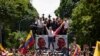 Opposition leader Maria Corina Machado holds a national flag while waving to supporters as she arrives for a rally in Caracas, Venezuela, Aug. 3, 2024.