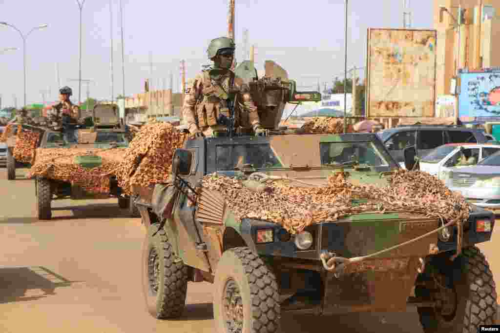 A convoy of French troops based in Niger drives by as they prepare to leave Niger, in Niamey. REUTERS/Mahamadou Hamidou