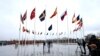 FILE - Members of the military raise the flag of Sweden on its newly installed pole during a ceremony to mark the accession of Sweden to NATO at NATO headquarters in Brussels, March 11, 2024. 