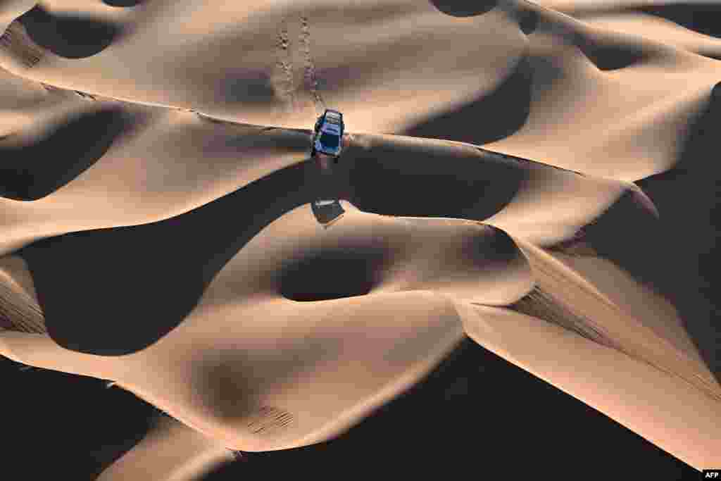 Team Nasser Racing&#39;s Qatari driver Nasser Al-Attiyah and his French co-driver Mathieu Baumel steer their car in the dunes during the second part of the 48h-chrono stage of the Dakar rally 2024, between Shubaytah and Shubaytah, Saudi Arabia, Jan. 12, 2024.