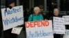 FILE - Whistleblower supporters demonstrate outside the Australian Capital Territory Supreme Court on June 27, 2019, in Canberra, Australia, where former army lawyer David McBride appeared, charged with leaking secret documents.