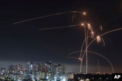 FILE - Israel's Iron Dome missile defense system fires interceptors at rockets launched from the Gaza Strip, in Ashkelon, southern Israel. Thursday, May 11, 2023. (AP Photo/Tsafrir Abayov, File)