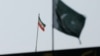 The flag of Iran is seen over its consulate building, with Pakistan's flag in the foreground, in Karachi, Pakistan, Jan. 18, 2024. 