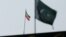 The flag of Iran is seen over its consulate building, with Pakistan's flag in the foreground, in Karachi, Pakistan, Jan. 18, 2024. 