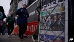 10月21日英国伦敦威斯敏斯特地铁站进出口处的售报箱上的《伦敦标准晚报》第一版上的标题写着“竞选首相角逐正酣”。