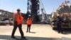 Workers stand at the Khurais oil field in Khurais, Saudi Arabia, Sept. 20, 2019. The OPEC+ coalition on Oct. 5, 2022, slashed production by 2 million barrels a day.