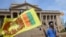 FILE - A man wears a headband with a slogan against interim Sri Lankan President Ranil Wickremesinghe as he waves the Sri Lankan national flag near the Presidential secretariat in Colombo, July 17, 2022. 
