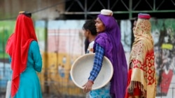 FILE - Laborers work at a road construction site in Prayagraj, India, Nov. 13, 2021.