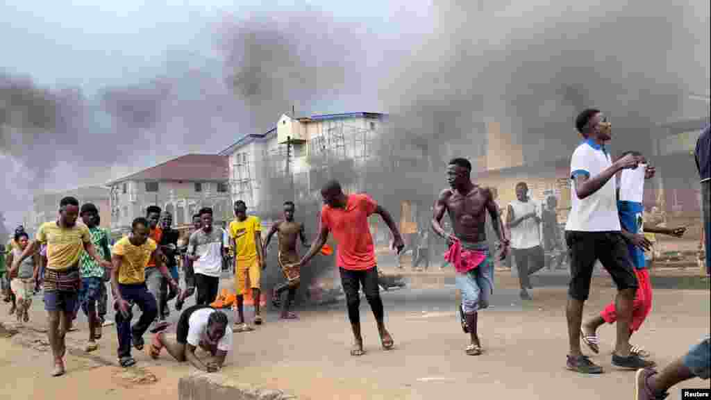 People run away during an anti-government protest in Freetown, Sierra Leone, Aug. 10, 2022 in this picture obtained from social media.