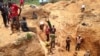FILE - In this photograph taken on Apr. 4, 2018, gold miners work at a mining site in the Cameroon town of Betare Oya.