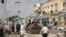FILE - Police and military officials comb the scene of an al-Shabab group militant attack in Mogadishu, Aug. 21, 2022.
