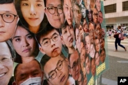 资料照片：画有香港民主派活动人士头像的横幅。(2021年7月1日)