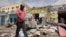 FILE - Residents look at the scene of an al-Qaida-linked al-Shabab group militant attack, in Mogadishu, Somalia, Aug. 21, 2022. 