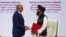 FILE -Mullah Abdul Ghani Baradar, the leader of the Taliban delegation, and Zalmay Khalilzad, U.S. envoy for peace in Afghanistan, shake hands after signing an agreement between members of Afghanistan's Taliban and the U.S., in Doha, Qatar, Feb. 29, 2020.