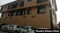 Cars are parked in front of media conglomerate Vision Media Services Limited in Jabi, Nigeria. (Timothy Obiezu/VOA)