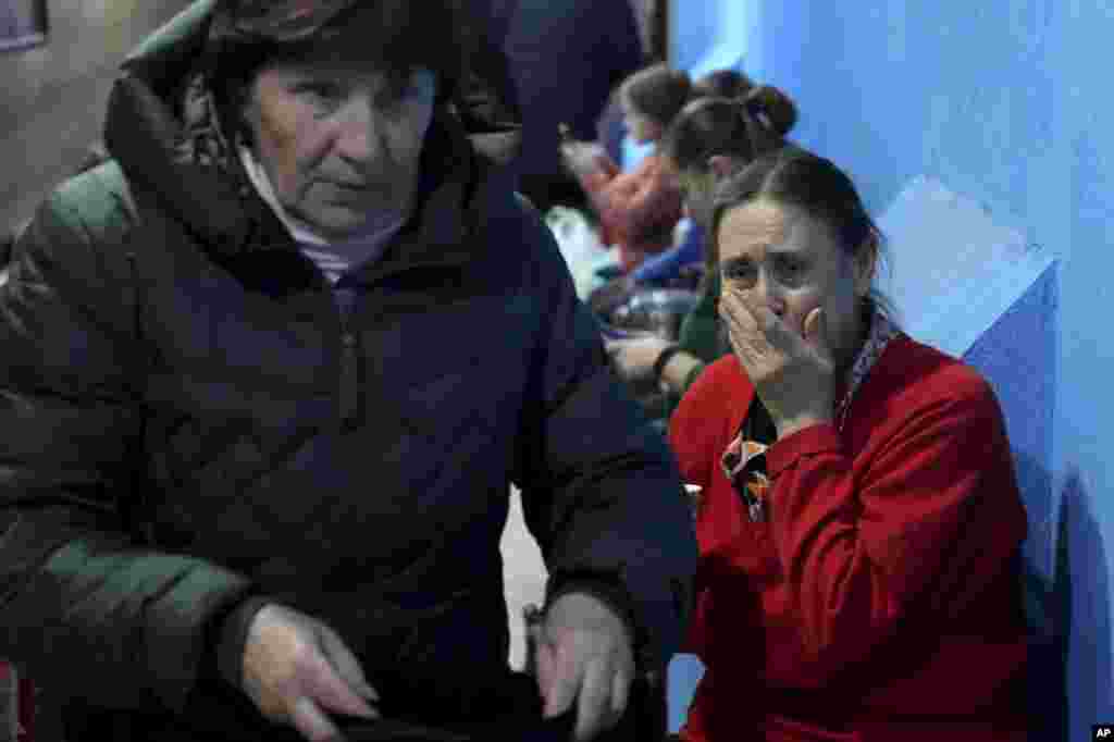 People take shelter inside a building in Mariupol, Ukraine, Feb. 27, 2022. Street fighting broke out in Ukraine&#39;s second-largest city and Russian troops squeezed strategic ports in the country&#39;s south as the prospect of peace talks remains uncertain.