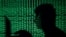 FILE - A man holds a laptop computer as cyber code is projected on him in this illustration picture taken on May 13, 2017.