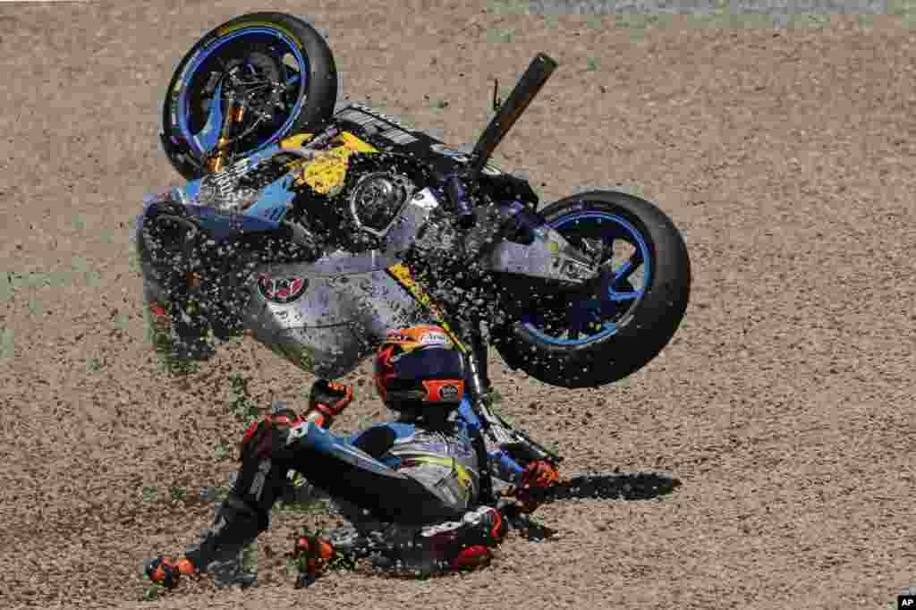 MotoGP rider Tito Rabat of Spain falls from his bike at the Spanish Motorcycle Grand Prix at the Jerez racetrack in Jerez de la Frontera.