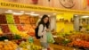 FILE - Personal trainer Antonia Kalantzi, 38, shops at a grocery store in Athens, Feb. 16, 2022.