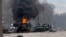 A Russian armored personnel carrier burns amid damaged and abandoned light utility vehicles after fighting in Kharkiv, Ukraine, Feb. 27, 2022. 