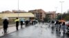 FILE - People line up in the rain outside a supermarket after the Italian island of Sicily closed them, as it tightens measures to try and contain the spread of coronavirus disease, in Catania, Italy, March 23, 2020.