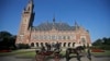 In this Aug. 28, 2013 file photo, a horse-drawn carriage stands in front of the Peace Palace, seat of the International Court of Justice (ICJ) in The Hague, Netherlands.